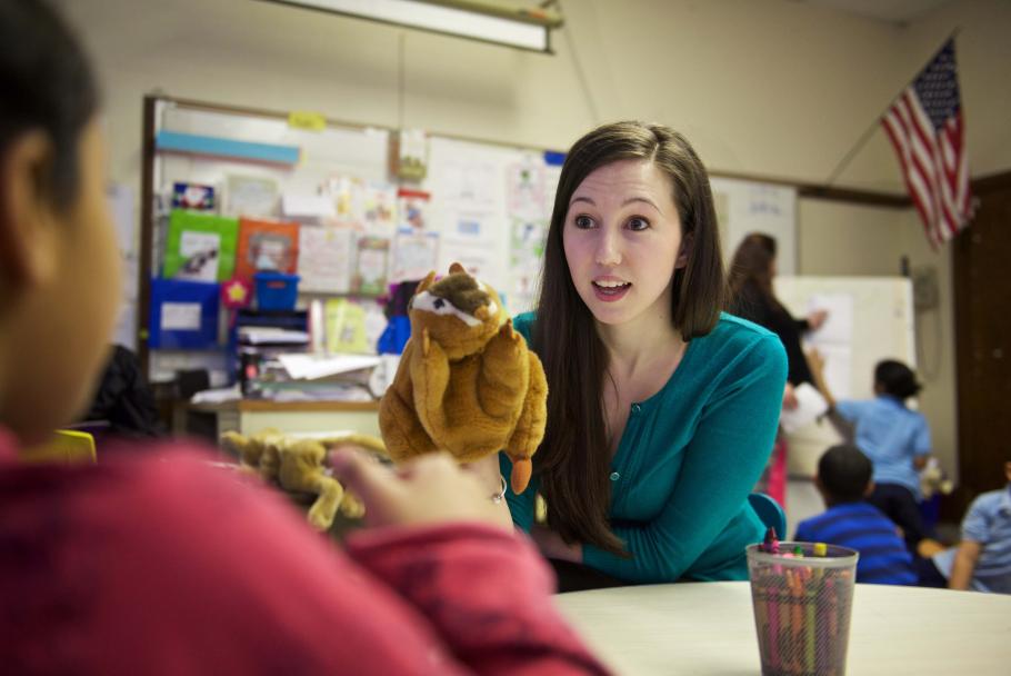 An M.S.W. student uses a puppet to work with primary school students during their internship.