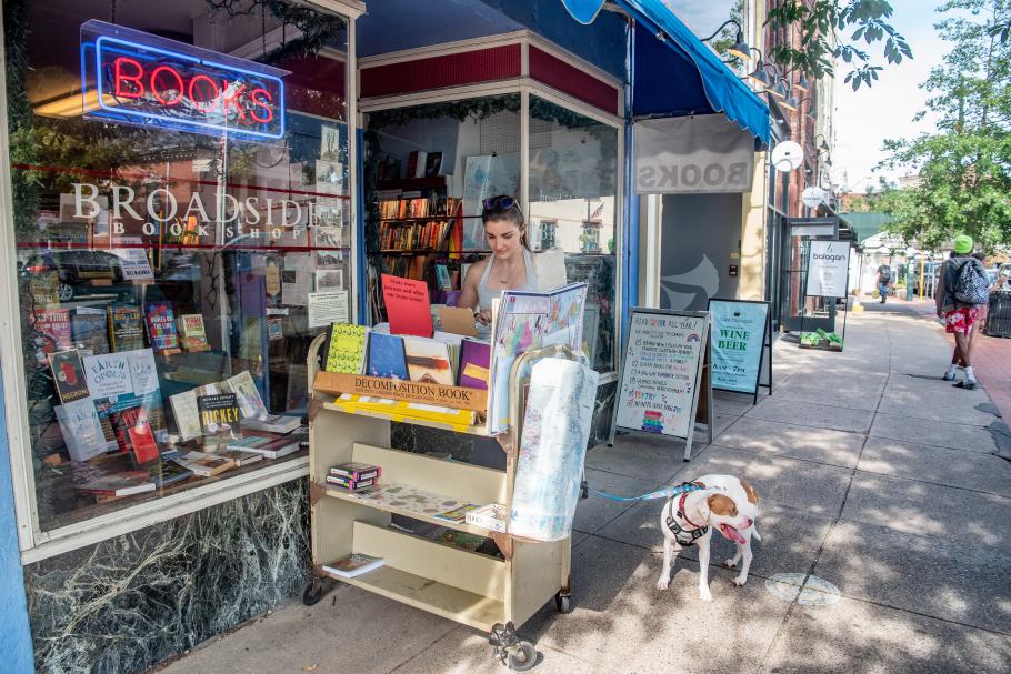 A student looks at books on a rolling cart outside Broadside Bookshop in downtown Northampton.