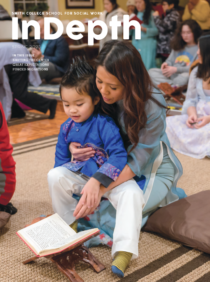 Cover of InDepth magazine from Spring 2023 featuring a mother and child sitting on the ground looking at a book during a prayer service.