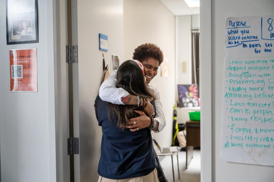 JD Fuller gives a student a supportive hug.