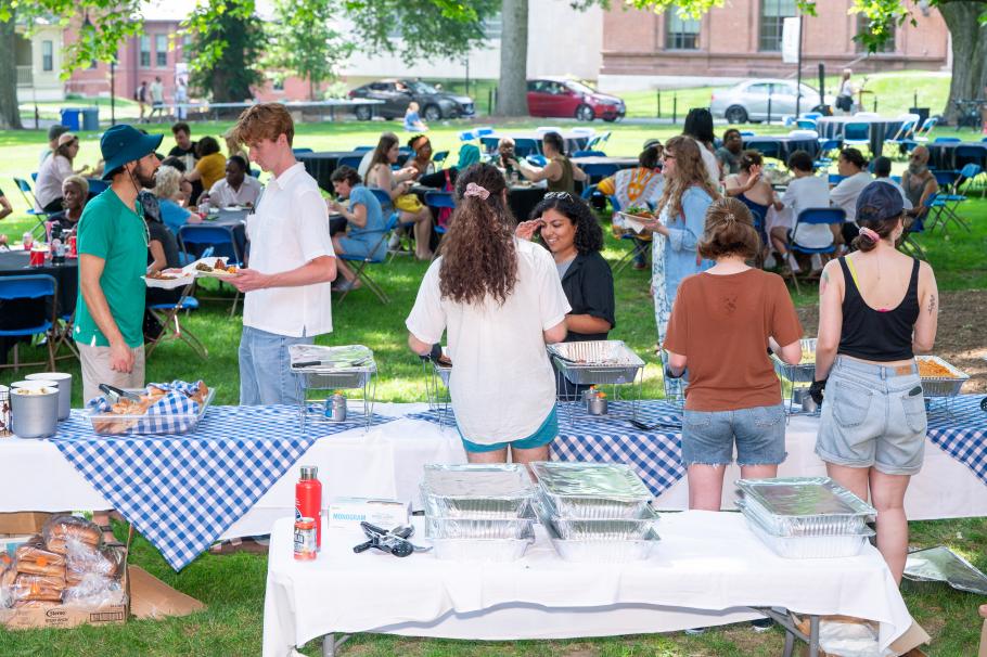 Students grabbing Naija food from a table