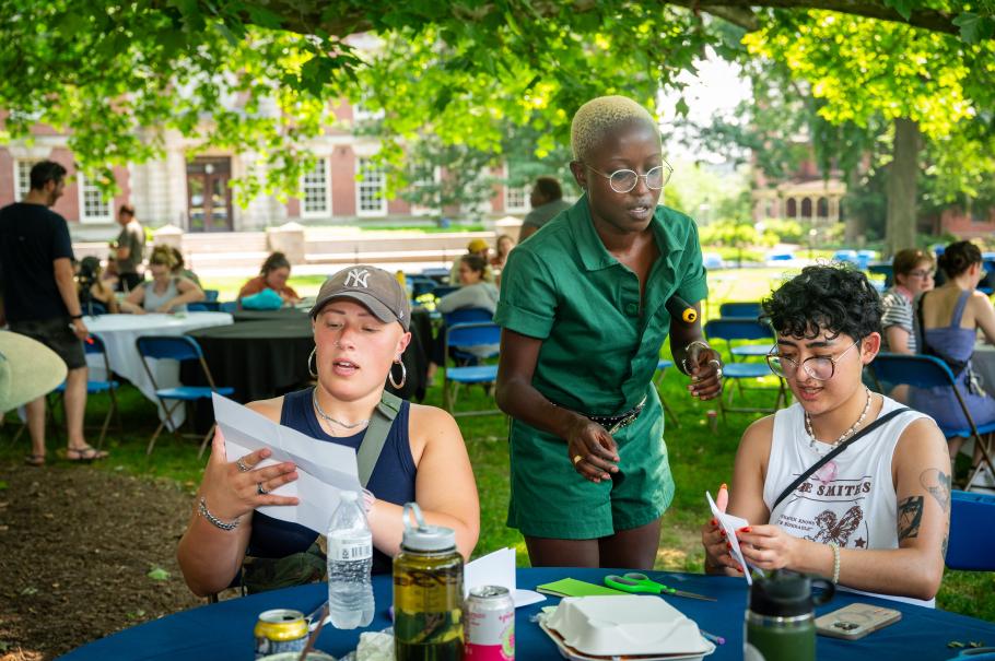 Oumou Sylla coaching students at a table