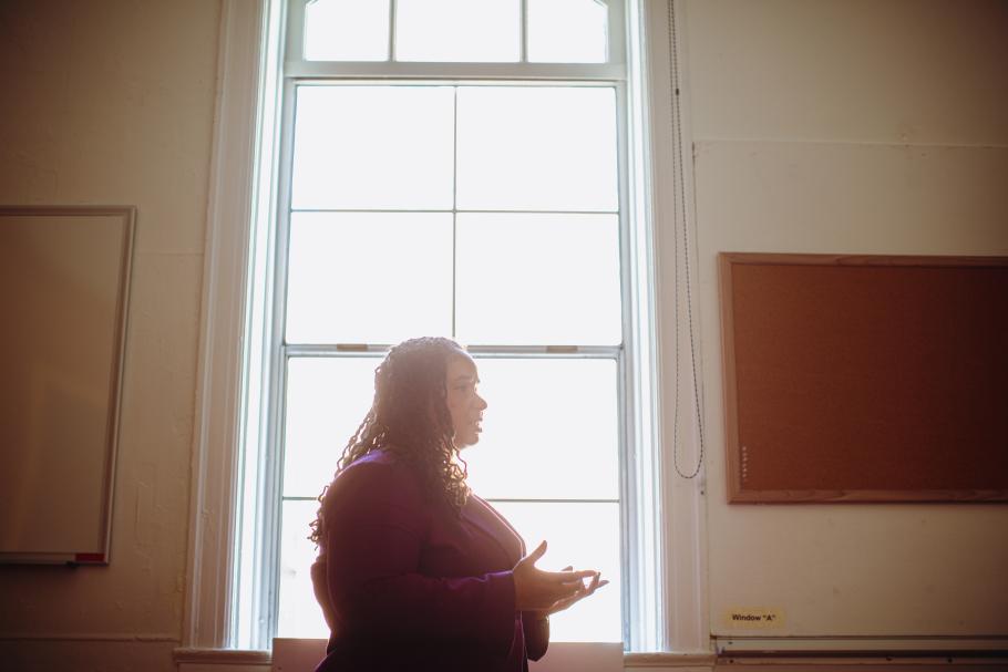 LaToya Lopez framed by a window in an office.