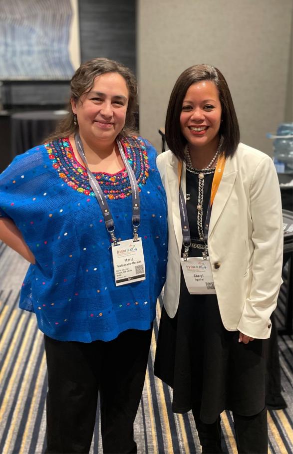 Maria Maldonado-Morales and Cheryl Aguilar stand side by side on a striped carpet