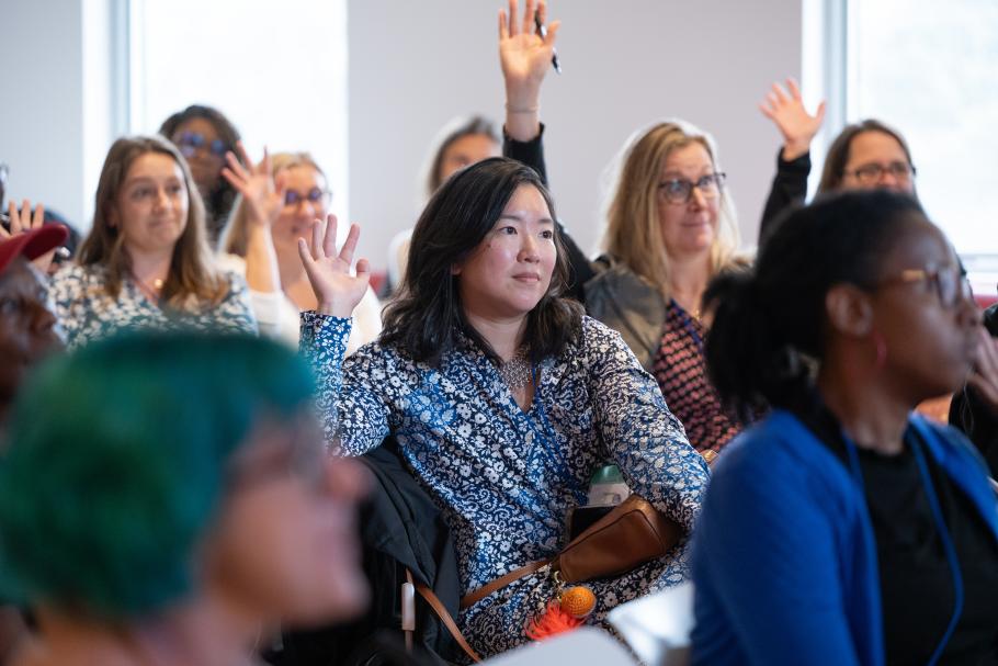 Participants in the 2025 Deepening Clinical Practice Conference raise their hands to ask questions at the end of a session.