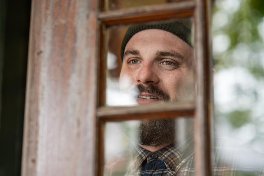 Lafayette Slaydon looks through the window of an exterior door.