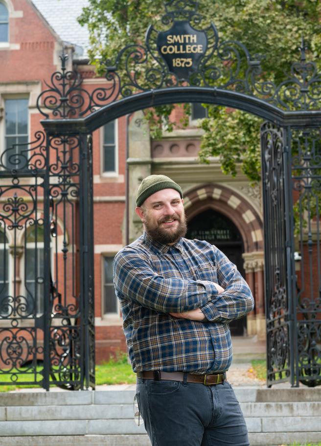 Lafayette Slaydon poses in front of the Grecourt Gates at Smith College