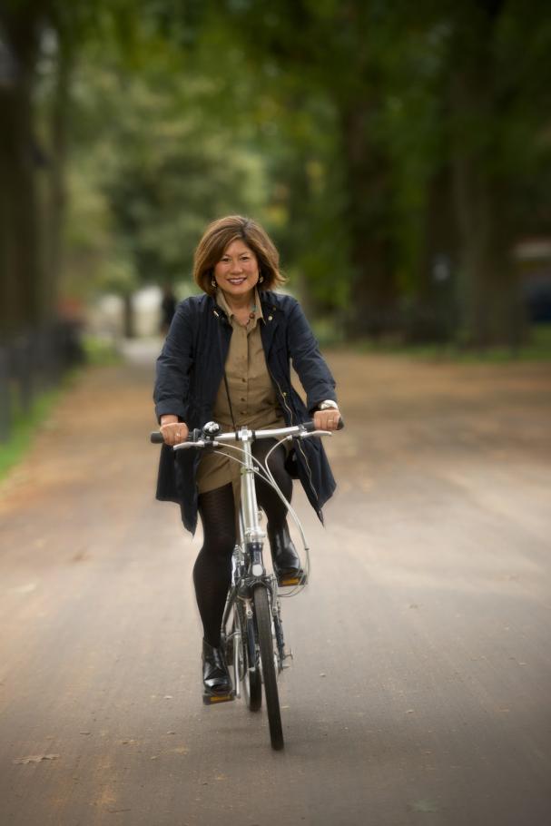 Marianne Yoshioka rides a bike toward the camera circa 2014