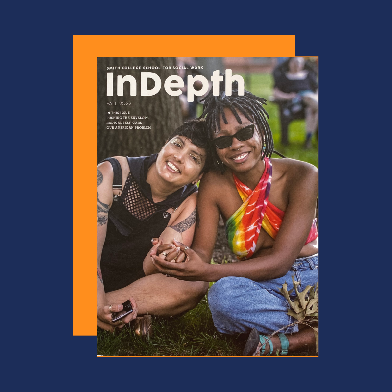 Cover of fall 2022 InDepth featuring two students smiling as they sit on the grass.