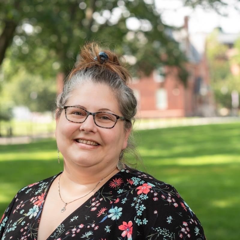 Marybeth Stratton stands outside and smiles at the camera. 