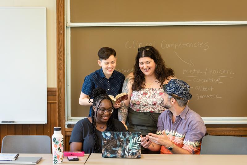 Four students work together in a classroom. 