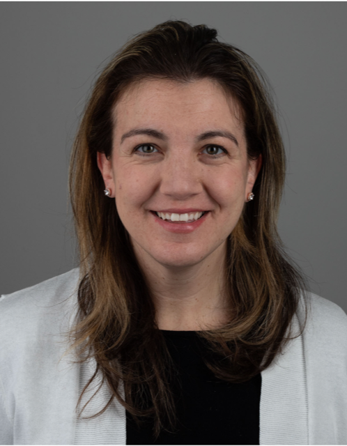 instructor johnna marcus smiles in front of a flat gray background