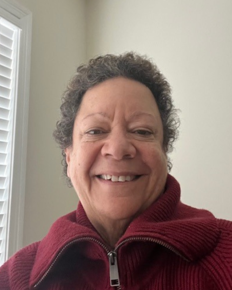 Carol Bonner smiles in red zip up fleece