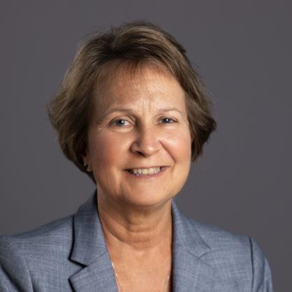 Portrait of Cathleen Morey wearing a blue blazer and black top. 