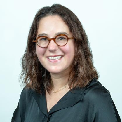 Naomi Gofine wearing black shirt and brown glasses smiling