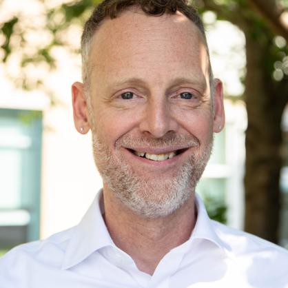 Jeffrey Steen headshot wearing white collared shirt