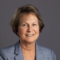 Portrait of Cathleen Morey wearing a blue blazer and black top. 