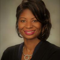 Portrait of Ronjonette O'Bannon wearing a black top and a necklace. 