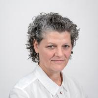 Sarah Bartholomew faces the camera wearing a white button down shirt.