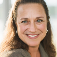 Elise Jacobsen close portrait smiling, green sweater