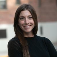 Judy Florio headshot outside with building behind