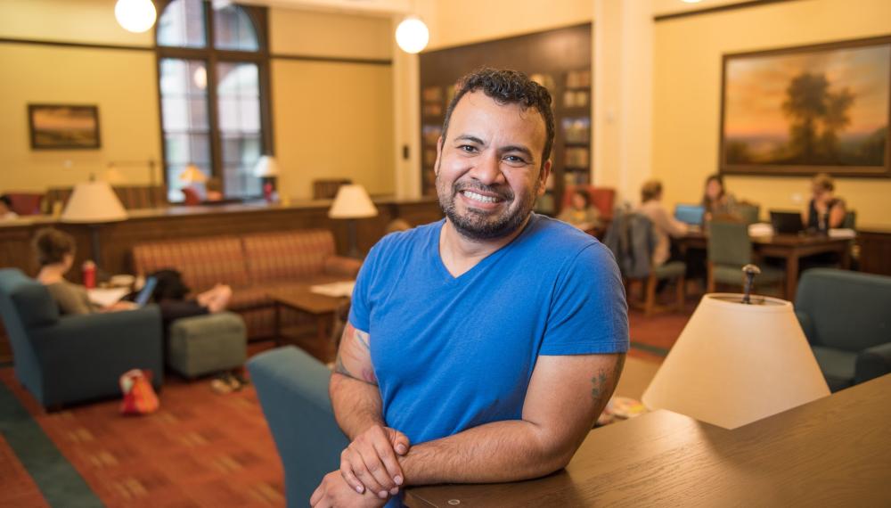 Jose Hernandez leans on a table smiling