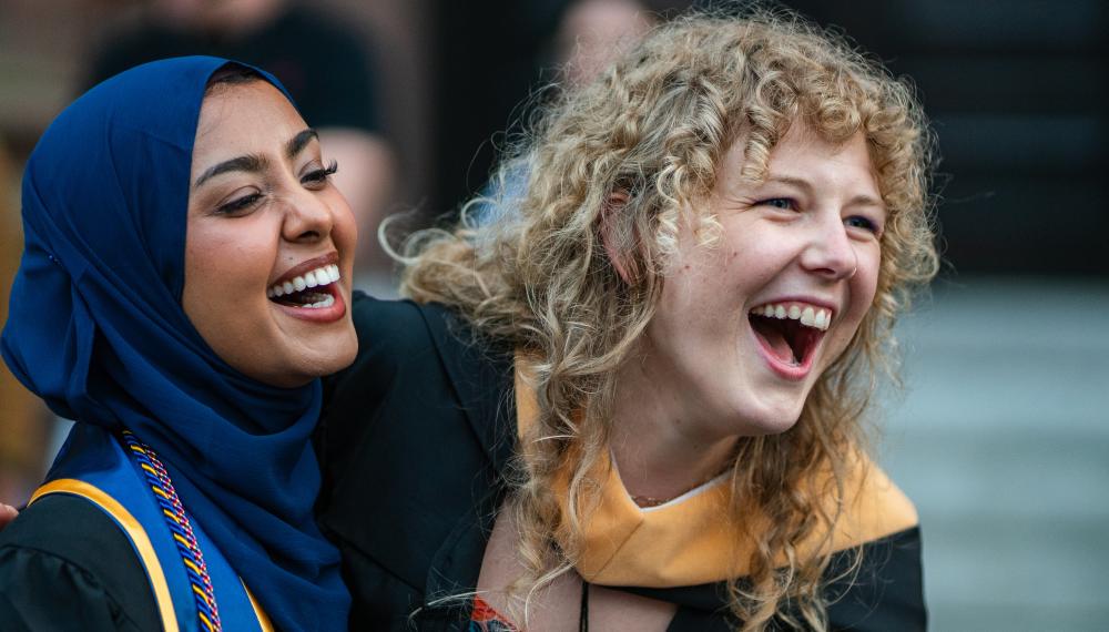 2024 M.S.W. graduates laugh at the conclusion of the 2024 commencement ceremony. 