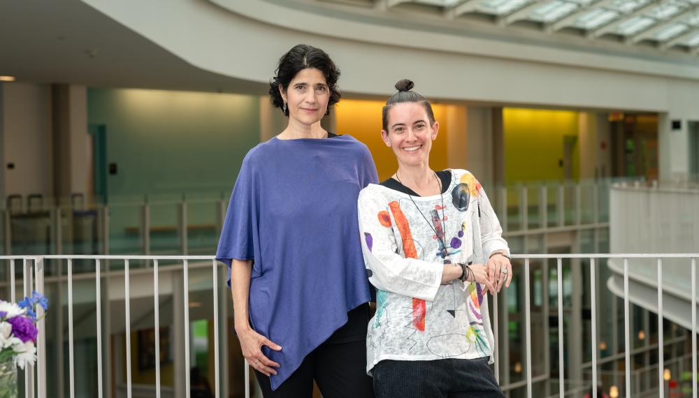 Ann Augustine and EJ Seibert standing on a balcony in the Campus Center