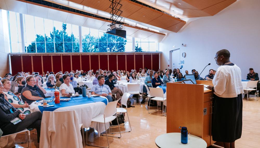 A room full of conference attendees listen carefully to the 2025 Keynote Speaker at the Deepening Clinical Practice Conference.