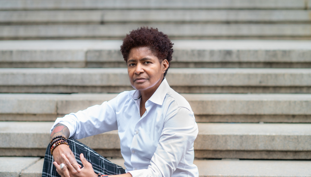 JD Fuller sitting on cement steps with hands clasped on knee
