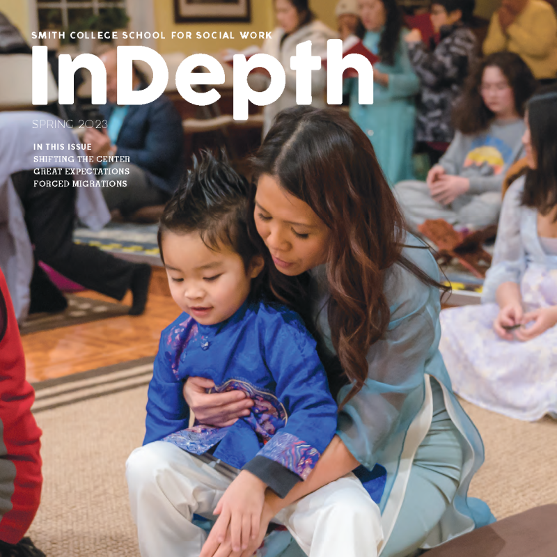 Cover of InDepth magazine from Spring 2023 featuring a mother and child sitting on the ground looking at a book during a prayer service.