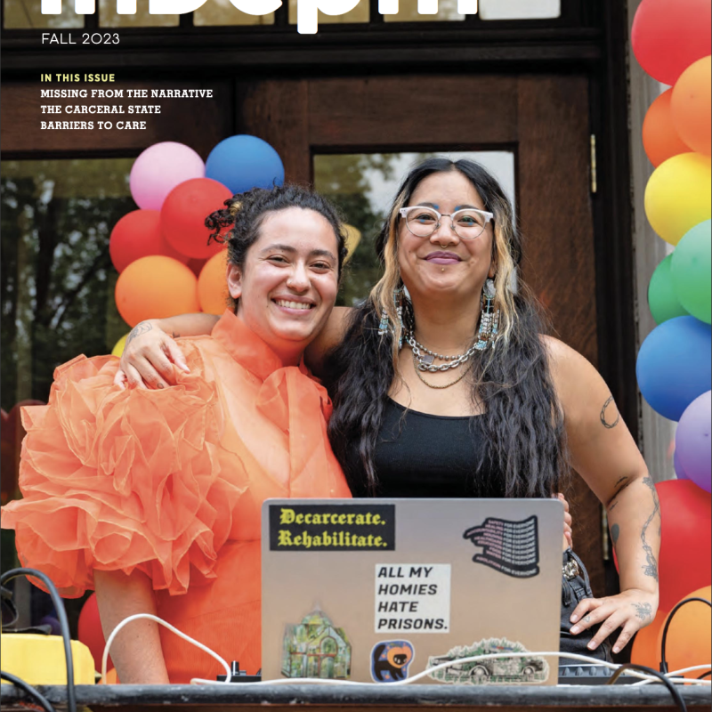 Cover of InDepth magazine from Fall 2023 featuring two students standing in front of a PRIDE balloon arch with a laptop open in front of them.
