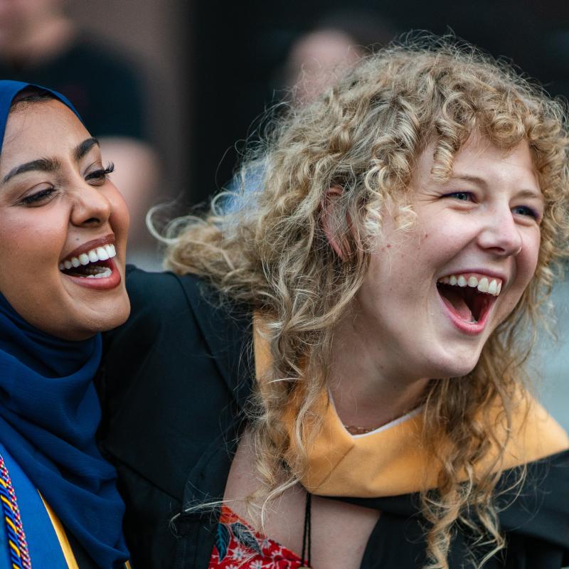 2024 M.S.W. graduates laugh at the conclusion of the 2024 commencement ceremony. 