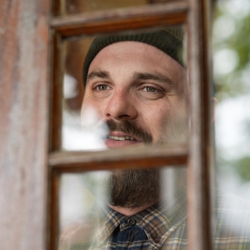 Lafayette Slaydon looks through the window of an exterior door.