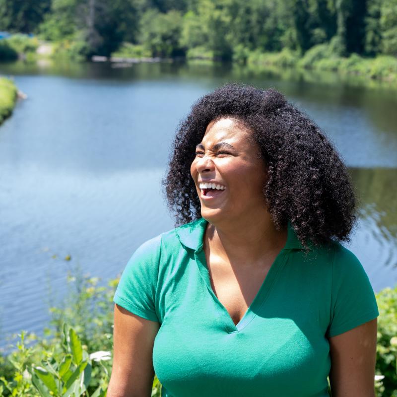 Alexis Minnis laughs in front of Paradise Pond