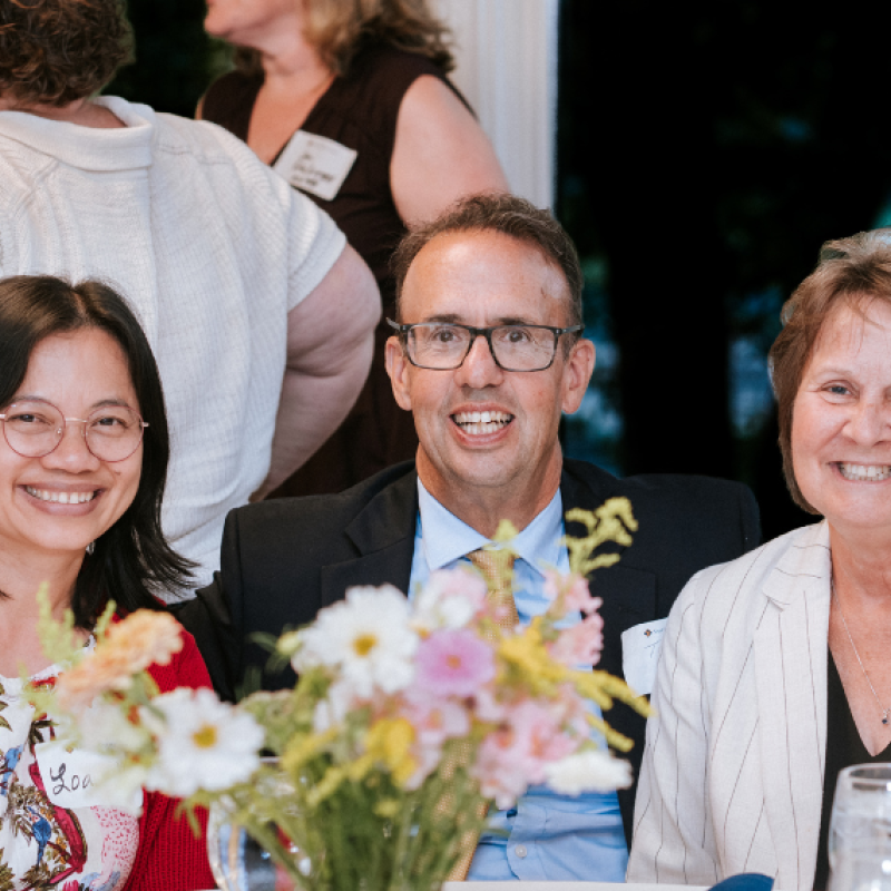 Cathleen Morey (R) sits with her husband and fellow alum Loan Vo at the 2025 Alumni Awards