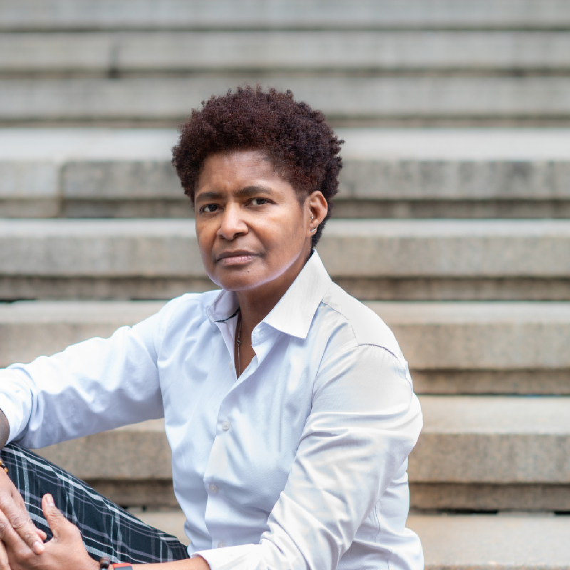 JD Fuller sitting on cement steps with hands clasped on knee