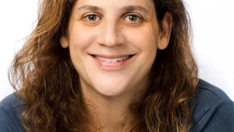 Danna Bodenheimer wearing blue shirt. White background